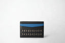 Black cardholder with yellow accent on a white background