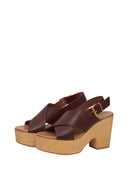 Brown platform sandals with wooden sole on a light gray background