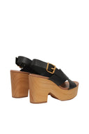 Black sandals with wooden soles on a white background
